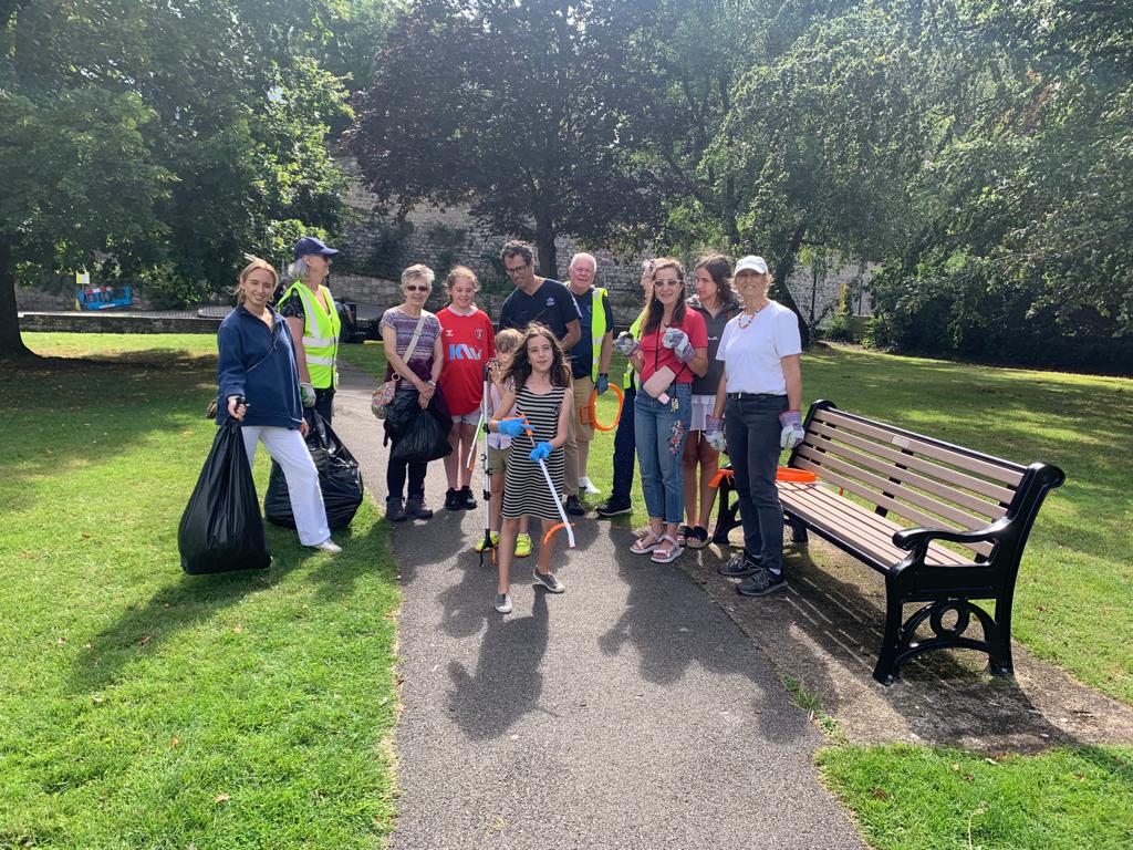 Volunteers of all ages pose after a volunteer session picking up litter from the Esplanade Gardens