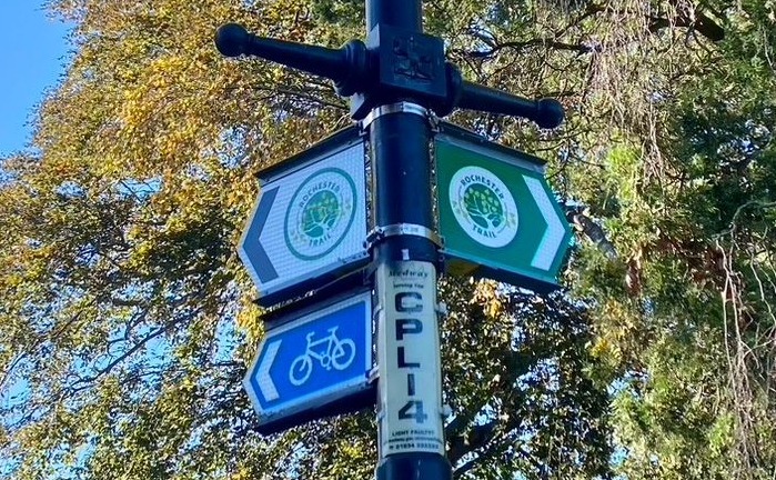 A classical lamp-post in Rochester with signs pointing out the route of the Rochester Trail