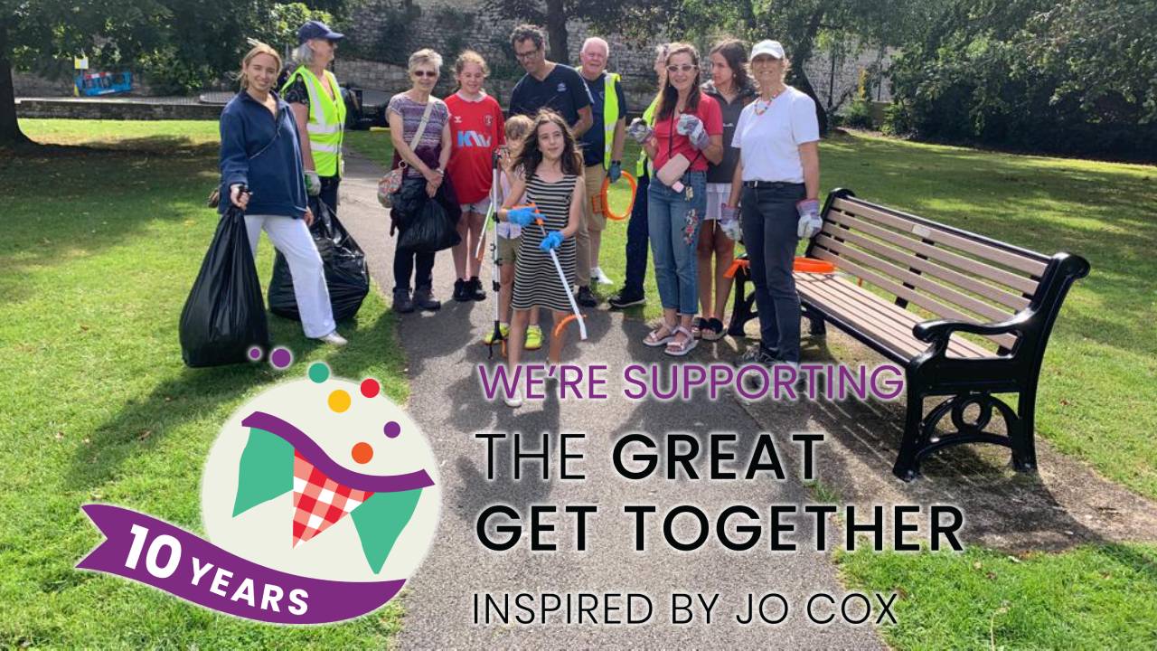 A group of volunteers or all ages pose after litter picking, above the Great Get Together logo and the words "We're Supporting the Great Get Together Inspired by Jo Cox"