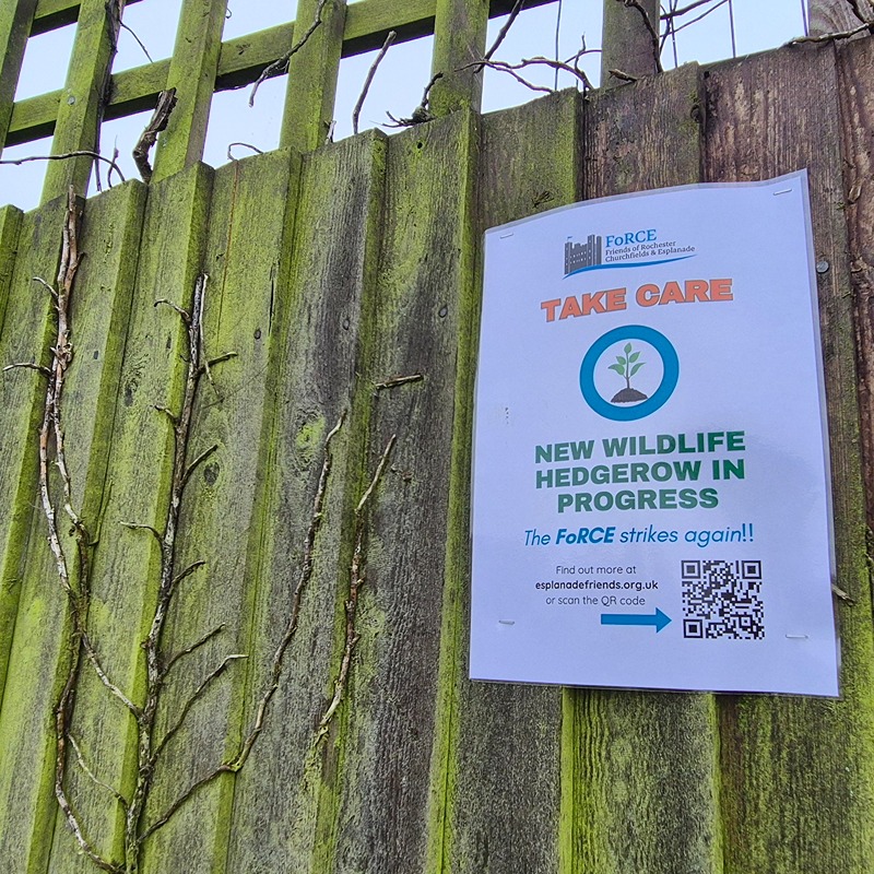 A sign on the fence asking people to keep away from the young whips